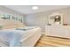 Bedroom with a ceiling fan, wood floors, plantation shutters, and a white dresser at 8035 Bayside View Dr, Orlando, FL 32819