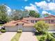Attractive villa with a red tile roof, two-car garage, and brick paver driveway at 8035 Bayside View Dr, Orlando, FL 32819