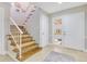 Inviting foyer with wood stairs, white railing, and a tile floor, creating a warm and welcoming entrance at 8035 Bayside View Dr, Orlando, FL 32819