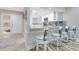 Open kitchen with bar seating featuring granite countertops, white cabinets, and wood floors at 8035 Bayside View Dr, Orlando, FL 32819