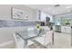 Bright eat-in kitchen features a glass dining table, white cabinets, and stainless steel appliances at 8035 Bayside View Dr, Orlando, FL 32819