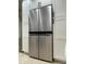 Stainless steel, french door refrigerator flanked by white cabinets at 8035 Bayside View Dr, Orlando, FL 32819
