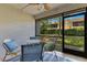 Outdoor lanai with seating, string lights and a view of the green backyard and neighborhood at 8035 Bayside View Dr, Orlando, FL 32819