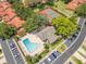 Aerial shot of the community pool, tennis courts, and clubhouse surrounded by lush landscaping and parking at 8035 Bayside View Dr, Orlando, FL 32819