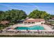 Relax by the community pool with lounge chairs and umbrellas next to the clubhouse and tennis courts at 8035 Bayside View Dr, Orlando, FL 32819