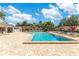 Community pool with brick-paved deck, seating, and sunny skies at 8035 Bayside View Dr, Orlando, FL 32819