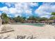 Community pool featuring outdoor seating and lush tropical landscaping at 8035 Bayside View Dr, Orlando, FL 32819