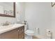 A powder room featuring a modern vanity with a white countertop and dark wood cabinets at 8035 Bayside View Dr, Orlando, FL 32819