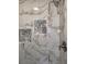 Close up of a fully tiled updated shower with built in shelving for storage at 8035 Bayside View Dr, Orlando, FL 32819