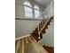 Staircase landing with white railing, arch windows with shutters, and wood floors at 8035 Bayside View Dr, Orlando, FL 32819
