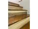 Close-up of hardwood staircase steps showcasing the unique wood grain and quality craftsmanship at 8035 Bayside View Dr, Orlando, FL 32819