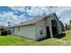 Exterior view of the home showing the backyard and covered patio area at 807 Knightsbridge Cir, Davenport, FL 33896