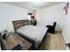 Simple bedroom with a wood frame bed, desk, and dresser with ample natural light at 807 Knightsbridge Cir, Davenport, FL 33896