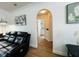 Hallway leading to a bathroom and other rooms featuring modern design and wood floors at 807 Knightsbridge Cir, Davenport, FL 33896