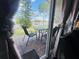 Exterior patio with a table and chairs, surrounded by a lush green lawn and trees at 807 Knightsbridge Cir, Davenport, FL 33896