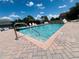 Community pool featuring a zero entry point and brick paver trim offers a relaxing spot for residents at 807 Knightsbridge Cir, Davenport, FL 33896