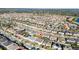 Expansive aerial view of a community showing the property's placement with surrounding homes and a pond at 8085 Ludington Cir, Orlando, FL 32836