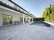 Backyard featuring a patio, pool, outdoor dining area, and sliding glass doors at 8085 Ludington Cir, Orlando, FL 32836