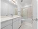 Clean bathroom featuring a sliding glass door shower and a white vanity with ample storage space at 8085 Ludington Cir, Orlando, FL 32836