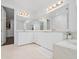 Elegant bathroom featuring dual sinks, large mirrors, and a luxurious bathtub for ultimate relaxation at 8085 Ludington Cir, Orlando, FL 32836
