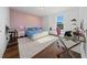 Comfortable bedroom with a plush blue bed, a workspace, and a large window offering natural light at 8085 Ludington Cir, Orlando, FL 32836
