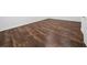 Close-up of beautiful hardwood floors with white baseboards, adding warmth and elegance at 8085 Ludington Cir, Orlando, FL 32836