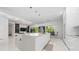 A spacious modern kitchen with a large center island, sleek white cabinets, and upscale lighting fixtures at 8085 Ludington Cir, Orlando, FL 32836