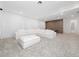 Spacious living room featuring a plush white sectional sofa, soft carpet, and a striking brown accent wall at 8085 Ludington Cir, Orlando, FL 32836