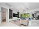 Modern living room with sleek finishes, a large window, and a view of the pool at 8085 Ludington Cir, Orlando, FL 32836