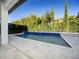Backyard pool area showcasing a rectangular pool with blue tile and manicured greenery at 8085 Ludington Cir, Orlando, FL 32836