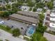 Overhead view of the building, surrounding greenery, parking spaces, and a refreshing community pool at 851 Miles Ave # 8, Winter Park, FL 32789