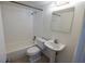Spotless bathroom with pedestal sink and tiled shower/tub combo for modern convenience at 851 Miles Ave # 8, Winter Park, FL 32789