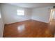 Bedroom with hardwood floors, neutral walls and a window with blinds at 851 Miles Ave # 8, Winter Park, FL 32789