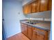 Functional kitchen with wood cabinets, stainless steel sink and counters at 851 Miles Ave # 8, Winter Park, FL 32789