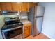 Efficient kitchen featuring stainless steel appliances and wooden cabinetry for a functional cooking space at 851 Miles Ave # 8, Winter Park, FL 32789