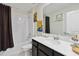 Stylish bathroom featuring a shower over tub, modern vanity, and elegant fixtures for a refreshing experience at 8975 Fluffy Lie Ct, Davenport, FL 33896
