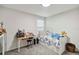 Charming bedroom with desk, single bed, and carpet, perfect for a or teen at 8975 Fluffy Lie Ct, Davenport, FL 33896