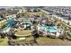 Aerial view of a resort-style community pool and clubhouse with inviting outdoor amenities at 8975 Fluffy Lie Ct, Davenport, FL 33896