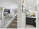 Inviting entryway featuring stairs, kitchen view, and decorative console table, blending functionality and style at 8975 Fluffy Lie Ct, Davenport, FL 33896