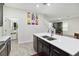 Open concept kitchen with white countertop, stainless steel appliances, and direct access to the stairway at 8975 Fluffy Lie Ct, Davenport, FL 33896
