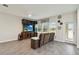 Comfortable living room includes a wall-mounted tv, large windows, and ceiling fan at 8975 Fluffy Lie Ct, Davenport, FL 33896