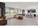 Spacious living room features hardwood floors and connects to a modern kitchen with breakfast bar at 8975 Fluffy Lie Ct, Davenport, FL 33896