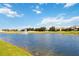 Scenic pond with a fountain feature surrounded by residential properties and golf course at 8975 Fluffy Lie Ct, Davenport, FL 33896