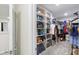 Large walk-in closet offers ample storage with organized shelving for clothing and accessories at 8975 Fluffy Lie Ct, Davenport, FL 33896