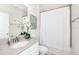 Clean and modern bathroom with a stylish vanity, framed art, and shower with white curtain at 9106 Cut Shot Dr, Winter Garden, FL 34787