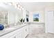 Luxurious bathroom featuring double sinks, granite countertop, a garden tub, and neutral décor at 9106 Cut Shot Dr, Winter Garden, FL 34787