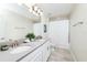 Bright bathroom featuring double sinks, ample counter space, modern fixtures, and neutral décor at 9106 Cut Shot Dr, Winter Garden, FL 34787