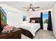 Cozy bedroom featuring nautical decor, carpet flooring, a queen bed, and natural light from the window at 9106 Cut Shot Dr, Winter Garden, FL 34787