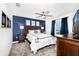 Stylist bedroom with a dark-blue accent wall, carpet flooring, a queen bed, and natural light from the window at 9106 Cut Shot Dr, Winter Garden, FL 34787
