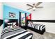 Colorful bedroom featuring twin beds with unique black-and-white themes and playful decor at 9106 Cut Shot Dr, Winter Garden, FL 34787